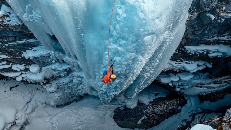 woman-climbing-frozen-waterfall-746-419.jpg